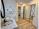 This bathroom features a vanity with a mirror and wood-look floors at 2829 Somerset Bay, Indianapolis, IN 46240