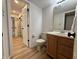 Clean bathroom featuring a vanity, toilet, and an open doorway, seamlessly connecting to other rooms at 2829 Somerset Bay, Indianapolis, IN 46240