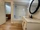 This bathroom features a tub with shower, vanity with a mirror, and wood-look floors at 2829 Somerset Bay, Indianapolis, IN 46240