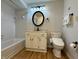 This bathroom features a tub with shower, toilet, vanity with a mirror, and wood-look floors at 2829 Somerset Bay, Indianapolis, IN 46240