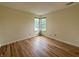 Bright bedroom with beautiful hardwood floors and a charming corner window showcasing natural light at 2829 Somerset Bay, Indianapolis, IN 46240