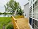 Beautiful wood deck overlooking a lush green lawn and lake creating a serene outdoor living space at 2829 Somerset Bay, Indianapolis, IN 46240
