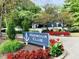 Harbour Club entrance sign surrounded by red flowers and lush greenery providing a welcoming entrance at 2829 Somerset Bay, Indianapolis, IN 46240