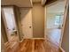 Well-lit hallway with hardwood floors, leading to a bathroom and bedroom, creating a seamless transition at 2829 Somerset Bay, Indianapolis, IN 46240