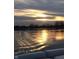 Serene lake view featuring still waters reflecting the sunset sky and surrounding trees at 2829 Somerset Bay, Indianapolis, IN 46240