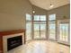 Bright living room with a fireplace, light wood floors, and large windows with serene views provides comfort at 2829 Somerset Bay, Indianapolis, IN 46240
