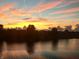 Beautiful and colorful sunset over the lake with silhouettes of homes in the background at 2829 Somerset Bay, Indianapolis, IN 46240