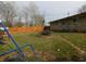 Spacious fenced backyard with play equipment offers ample space for outdoor activities at 2867 S Oakland Dr, Shelbyville, IN 46176