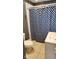Cozy bathroom featuring a vanity, toilet, and a blue patterned shower curtain at 2867 S Oakland Dr, Shelbyville, IN 46176