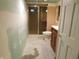 Unfinished bathroom with toilet, vanity, and glass-enclosed shower; ready to be updated at 2867 S Oakland Dr, Shelbyville, IN 46176