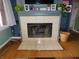 Close up of the living rooms fireplace, built in shelving and tile hearth at 2867 S Oakland Dr, Shelbyville, IN 46176