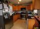 This kitchen is complete with wood cabinets, stainless steel appliances and tile flooring at 2867 S Oakland Dr, Shelbyville, IN 46176