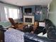 Cozy living room with a fireplace, built-in shelving, large windows, and comfortable leather seating at 2867 S Oakland Dr, Shelbyville, IN 46176