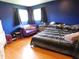 Bedroom with a bold blue walls, hardwood floors, and two windows at 2867 S Oakland Dr, Shelbyville, IN 46176