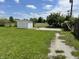Spacious backyard with a white shed and gravel walkway at 2927 E 8Th St, Anderson, IN 46012