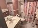 Cozy bathroom with pink tile walls, a vanity with mirror and a combination shower and bathtub at 2927 E 8Th St, Anderson, IN 46012