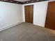 Empty bedroom with neutral walls, carpet and dark trim boasts ample space and natural light at 2927 E 8Th St, Anderson, IN 46012