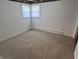 Empty bedroom features neutral walls, carpet and small windows offering plenty of natural light at 2927 E 8Th St, Anderson, IN 46012