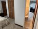 Bedroom connects to the bathroom and features a closet with shuttered doors and a floral bedspread at 2927 E 8Th St, Anderson, IN 46012