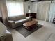 Bright and airy living room featuring a plush sofa and natural light through white curtains at 2927 E 8Th St, Anderson, IN 46012
