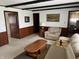 Cozy living room with wood paneled accent walls, exposed beams, and plush seating area at 2927 E 8Th St, Anderson, IN 46012