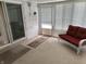 Bright sunroom with ample windows, seating, and neutral carpet at 2927 E 8Th St, Anderson, IN 46012