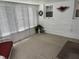 Sunroom featuring white brick walls, neutral carpet, and lots of light from the windows at 2927 E 8Th St, Anderson, IN 46012