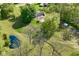 Stunning aerial view of a home with a private pond, grazing horses, and mature shade trees at 296 W Greencastle Rd, Mooresville, IN 46158
