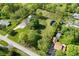 Aerial view showcasing the property's layout with home, pond, outbuildings and tree coverage at 296 W Greencastle Rd, Mooresville, IN 46158