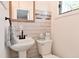 Charming bathroom with pedestal sink, framed mirror, and neutral tiled walls at 296 W Greencastle Rd, Mooresville, IN 46158