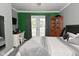 Modern bedroom featuring French door entry to outdoor living space and workspace at 296 W Greencastle Rd, Mooresville, IN 46158