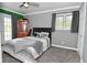 Modern bedroom with a ceiling fan, large window and view to outdoor living space at 296 W Greencastle Rd, Mooresville, IN 46158
