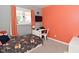 Bright bedroom with gray and orange walls, a built-in desk, and a large window at 296 W Greencastle Rd, Mooresville, IN 46158