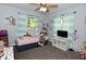 Spacious bedroom with large windows and modern ceiling fan, filled with decorations at 296 W Greencastle Rd, Mooresville, IN 46158