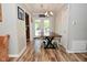 Charming dining area features a wooden table, stylish light fixture, and access to the backyard at 296 W Greencastle Rd, Mooresville, IN 46158