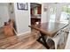 Dining area with wood-look flooring, rustic wooden table, and view into adjacent kitchen at 296 W Greencastle Rd, Mooresville, IN 46158