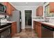 Well-lit kitchen featuring stainless steel appliances, wood cabinetry, and tile backsplash at 296 W Greencastle Rd, Mooresville, IN 46158