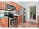 Updated kitchen boasts stainless steel appliances, ample cabinet space, and modern finishes at 296 W Greencastle Rd, Mooresville, IN 46158