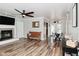 Spacious living room with a fireplace, wood floors, and an open floor plan at 296 W Greencastle Rd, Mooresville, IN 46158