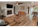 Inviting living room boasts a fireplace, hardwood floors and a ceiling fan at 296 W Greencastle Rd, Mooresville, IN 46158