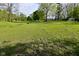 Large grassy pasture with scattered trees, outbuildings, and horses grazing peacefully at 296 W Greencastle Rd, Mooresville, IN 46158