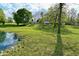 Scenic view of a pond, home, and outbuildings surrounded by green pasture at 296 W Greencastle Rd, Mooresville, IN 46158