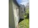 Side view of the home, showing utility connections, siding and yard at 3242 Collier St, Indianapolis, IN 46221