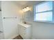 Bright bathroom with modern vanity, updated fixtures, and a large window providing natural light, creating a serene atmosphere at 3411 Chase St, Indianapolis, IN 46217