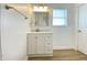 Bright bathroom featuring a modern vanity with white cabinets, updated fixtures and hardwood style floors at 3411 Chase St, Indianapolis, IN 46217