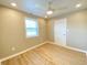 Bedroom features a ceiling fan, natural light from a window, and a bright color palette at 3411 Chase St, Indianapolis, IN 46217