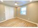 Cozy bedroom featuring a ceiling fan, natural light from a window, and hardwood style floors at 3411 Chase St, Indianapolis, IN 46217