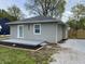 Well-kept single story home featuring new gray siding and a newly built wood fence in the spacious backyard at 3411 Chase St, Indianapolis, IN 46217