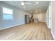 Open-concept living space with light wood flooring, recessed lighting, stainless appliances, and ample natural light at 3411 Chase St, Indianapolis, IN 46217