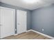 Bedroom with light walls, baseboards and flooring with two doors at 350 N Meridian N St # 701, Indianapolis, IN 46204